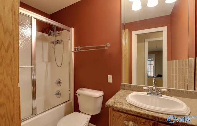 2220 Jefferson St, Courtland, AL 35618 - bathroom featuring toilet, vanity, and bath / shower combo with glass door