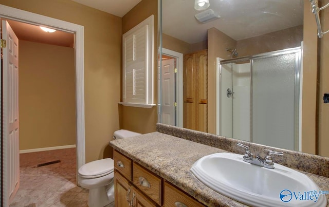 bathroom featuring vanity, tile patterned flooring, toilet, and an enclosed shower