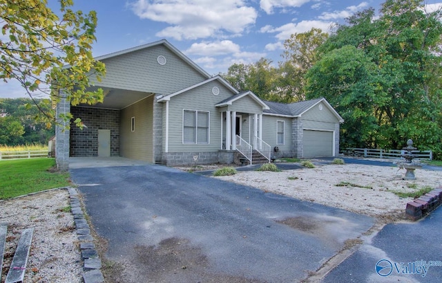 2220 Jefferson St, Courtland, AL 35618 - ranch-style house featuring fence, driveway, an attached garage, and a carport