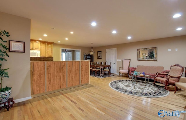 interior space featuring decorative light fixtures and light hardwood / wood-style flooring