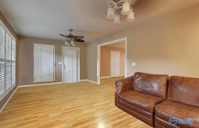 living room featuring light hardwood / wood-style flooring and ceiling fan