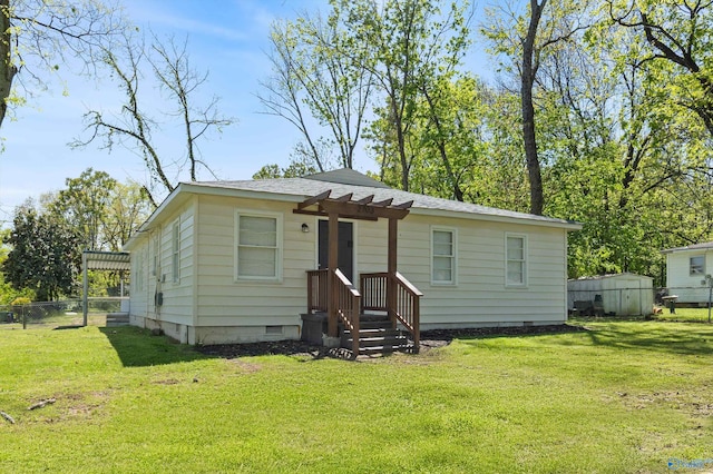 view of front of home with a front yard, crawl space, a pergola, and fence