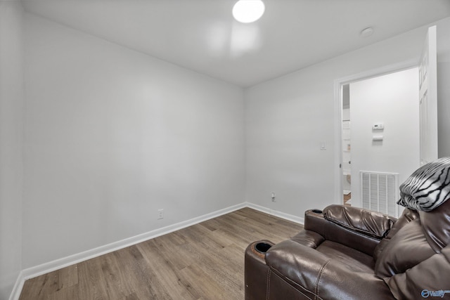 sitting room with visible vents, wood finished floors, and baseboards