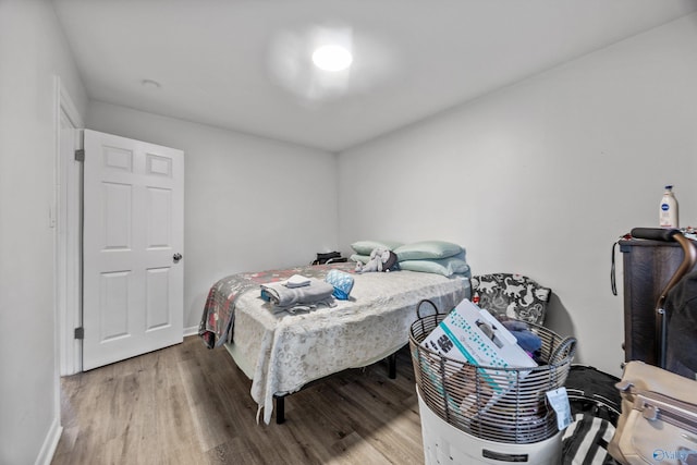bedroom featuring wood finished floors and baseboards