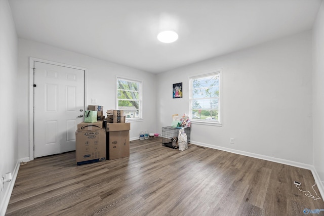 miscellaneous room featuring baseboards and wood finished floors