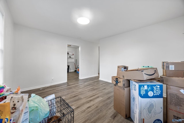 interior space featuring wood finished floors and baseboards