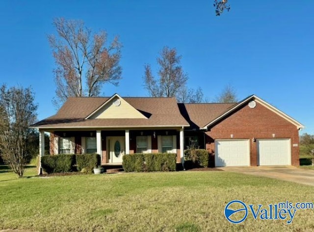 view of front of property with a garage and a front lawn