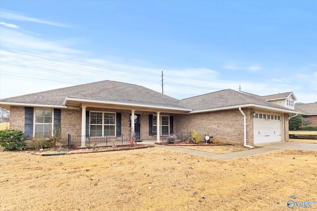 ranch-style home featuring a porch, a garage, and a front lawn