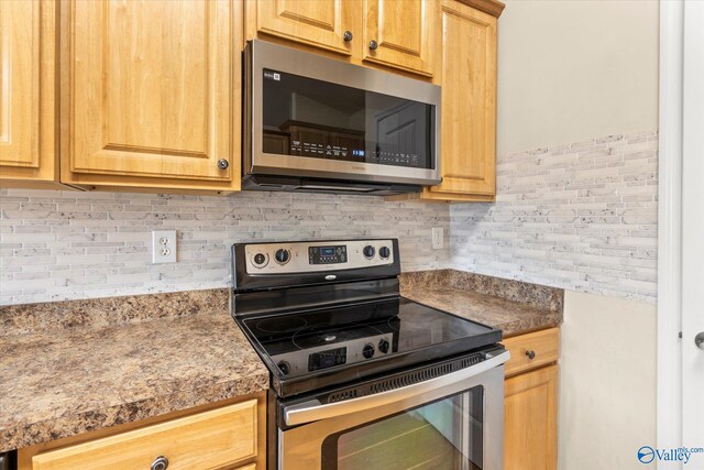 kitchen featuring appliances with stainless steel finishes and backsplash