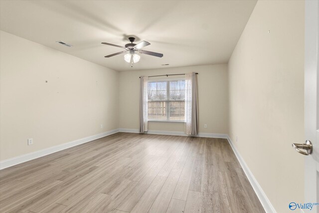 spare room featuring ceiling fan and light hardwood / wood-style floors