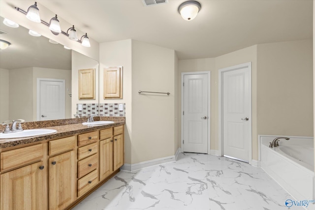 bathroom featuring vanity and a tub