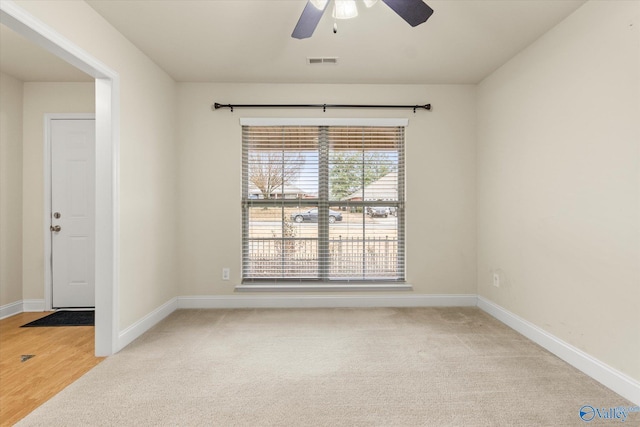 carpeted empty room featuring ceiling fan