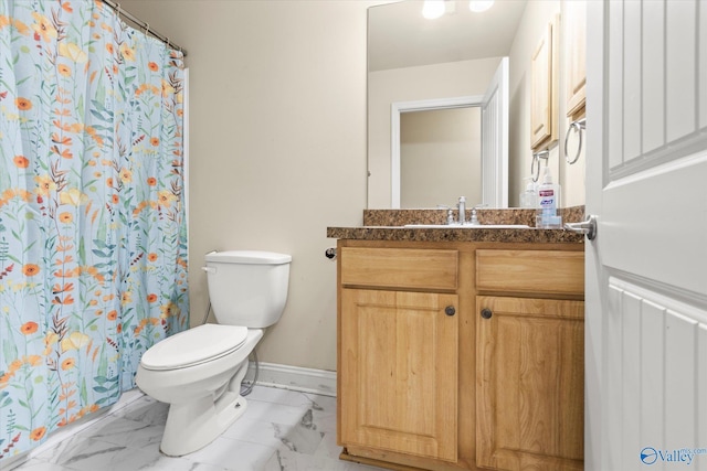 bathroom featuring vanity, curtained shower, and toilet