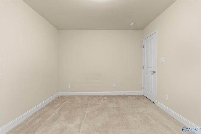 unfurnished room featuring light carpet