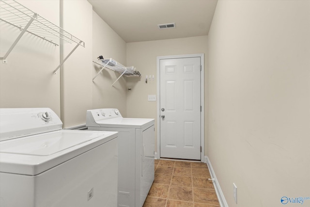 clothes washing area featuring independent washer and dryer