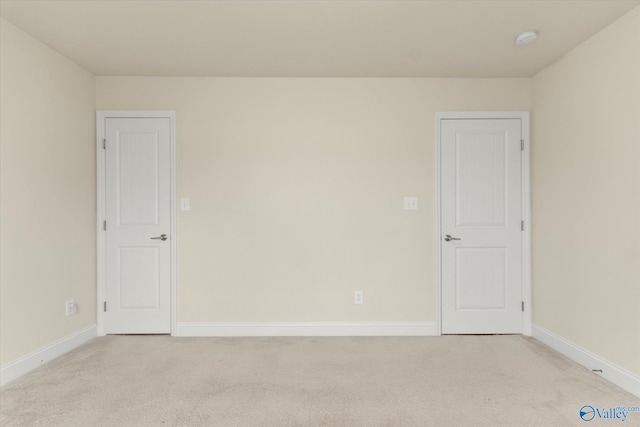 empty room featuring light colored carpet