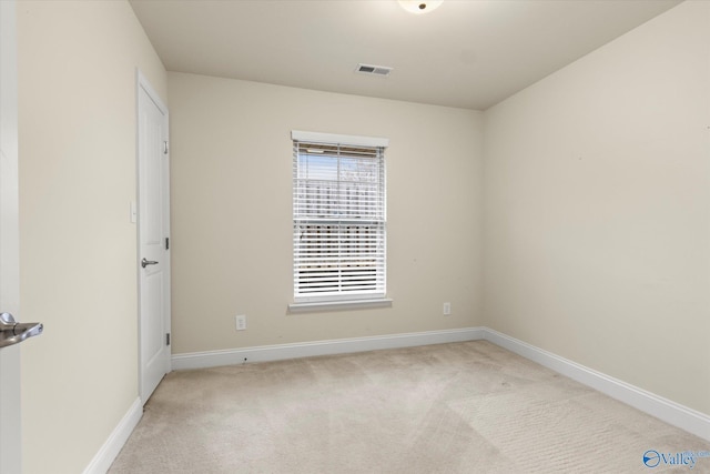 unfurnished room featuring light colored carpet