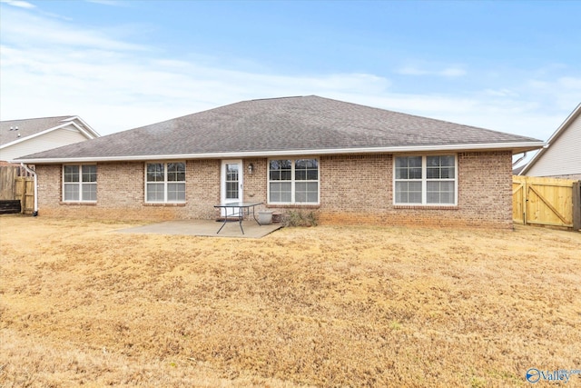 back of house with a yard and a patio area