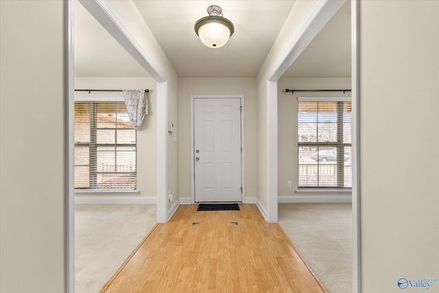 doorway featuring light carpet