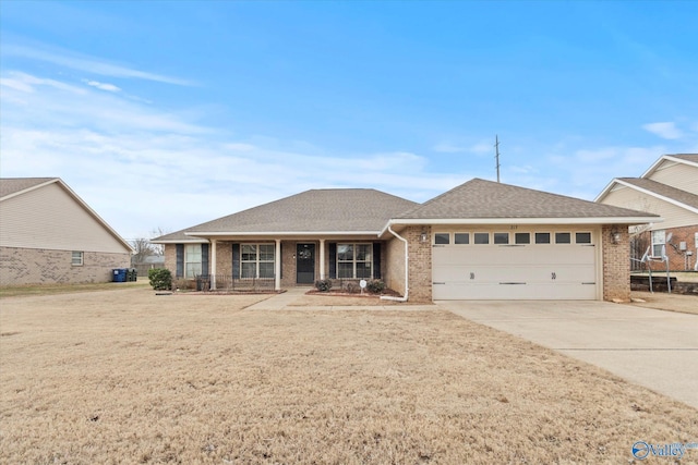 view of front of house with a garage, a porch, and a front yard