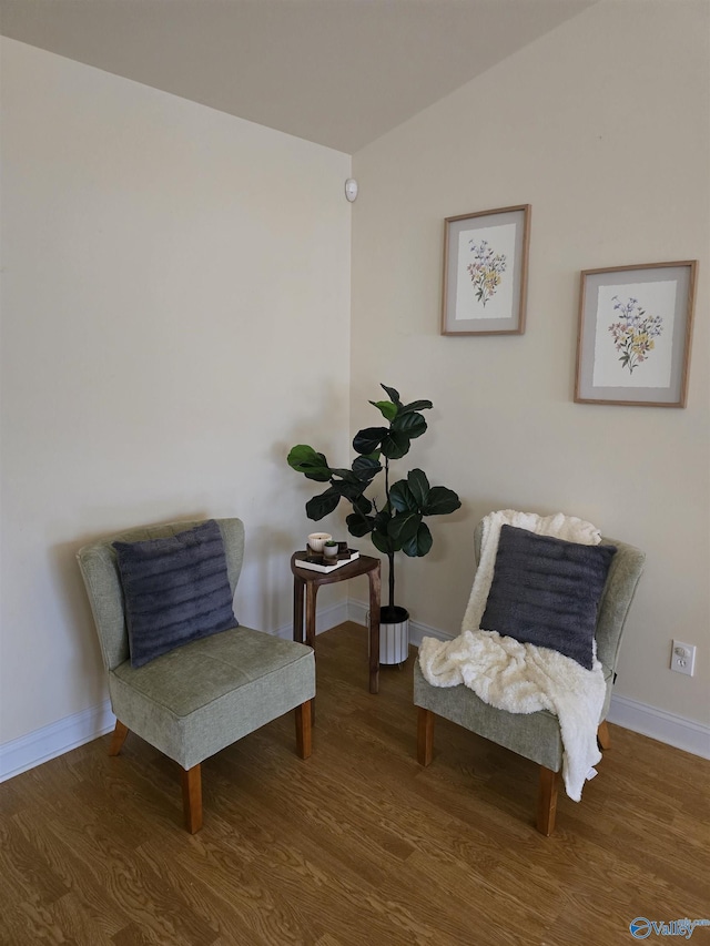 sitting room with wood-type flooring