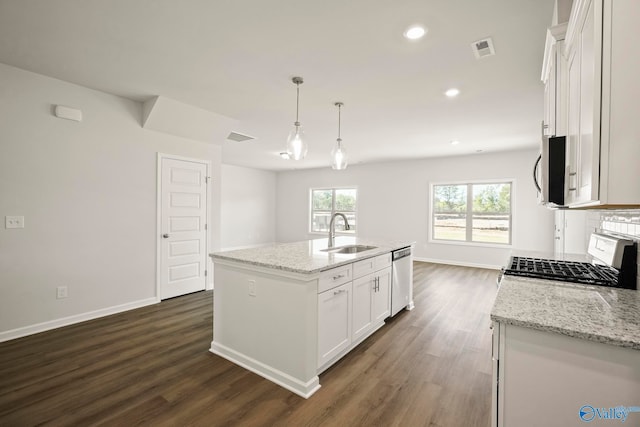 kitchen featuring a center island with sink, sink, appliances with stainless steel finishes, and white cabinetry