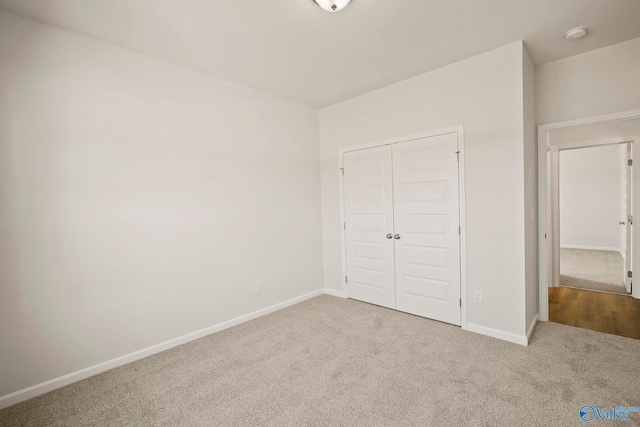 unfurnished bedroom featuring a closet and carpet flooring