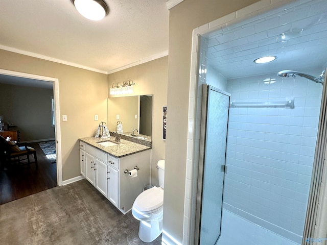 bathroom with vanity, wood-type flooring, ornamental molding, toilet, and a shower with door