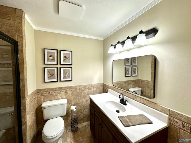 bathroom with tile walls, a textured ceiling, crown molding, vanity, and toilet