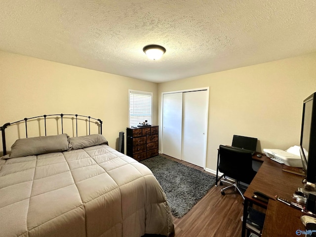 bedroom featuring a closet, hardwood / wood-style floors, and a textured ceiling