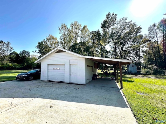 garage featuring a yard and a carport