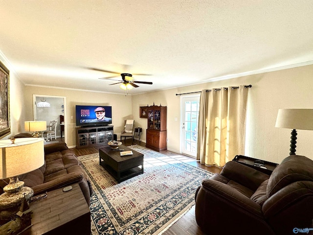 living room featuring a textured ceiling, ornamental molding, ceiling fan, and hardwood / wood-style flooring