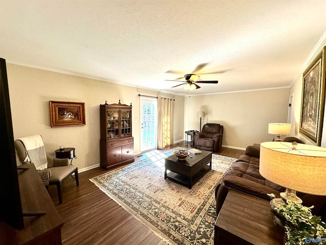 living room featuring ceiling fan, a textured ceiling, ornamental molding, and wood-type flooring