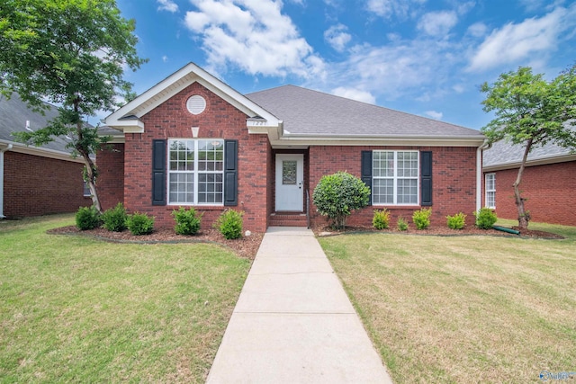 single story home with brick siding, a front lawn, and a shingled roof