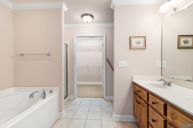 full bathroom featuring baseboards, crown molding, a shower stall, a garden tub, and vanity