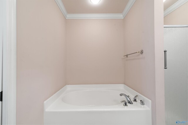full bath with a garden tub and crown molding