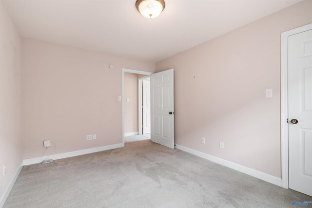unfurnished bedroom with carpet and baseboards