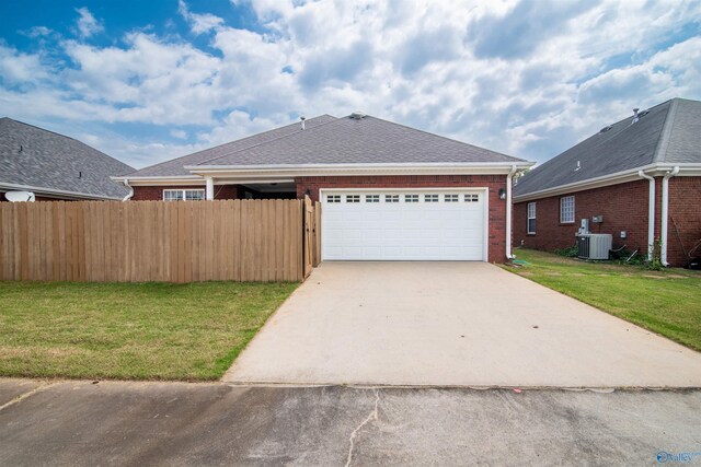 ranch-style house featuring brick siding, central AC unit, driveway, and an attached garage
