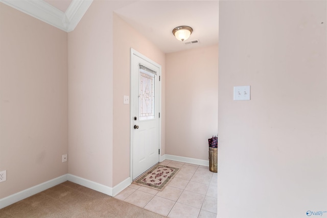 entryway with ornamental molding, baseboards, and light tile patterned flooring