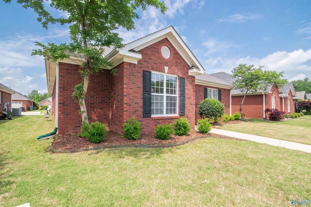 single story home with a front yard and brick siding