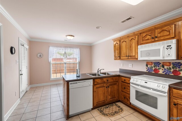 kitchen featuring white appliances, a sink, ornamental molding, dark countertops, and brown cabinetry