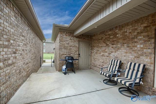 view of patio with area for grilling and fence