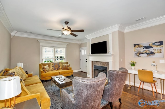 living room with visible vents, dark wood-type flooring, ornamental molding, a fireplace, and baseboards