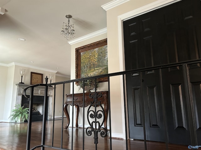 interior space featuring ornamental molding, wood-type flooring, and a chandelier