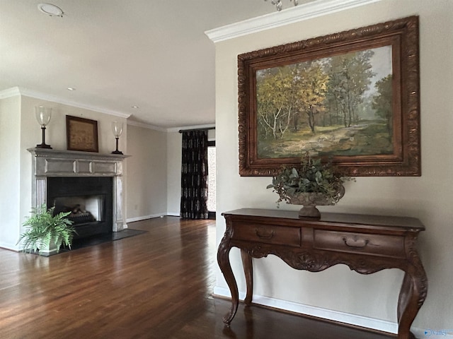 hall with dark wood-type flooring and ornamental molding