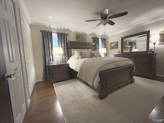 bedroom featuring ornamental molding, dark wood-type flooring, and ceiling fan