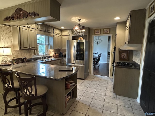 kitchen featuring sink, a breakfast bar area, light tile patterned floors, kitchen peninsula, and stainless steel appliances