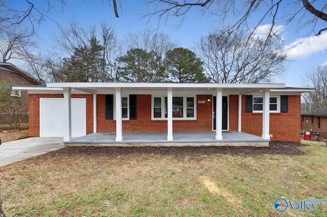 ranch-style home with a garage, covered porch, and a front yard