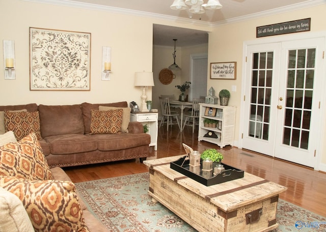 living room with french doors, ornamental molding, a ceiling fan, and wood finished floors
