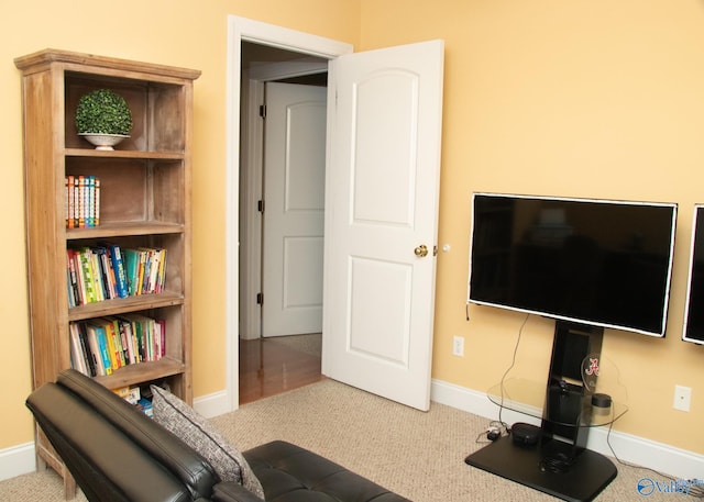 living area with baseboards and carpet flooring